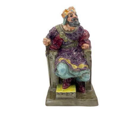 This Large figurine of the king dressed in purple tunic, maroon cloak, with teal-colored pants sitting on his throne. Royal D