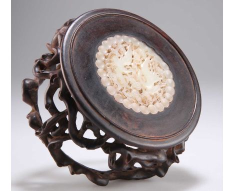 A CHINESE CARVED HARDWOOD AND JADE VASE STAND inset with a carved and pierced jade plaque depicting a pair of cranes above a 