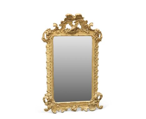 A ROCOCO REVIVAL GILT-COMPOSITION MIRROR, 19TH CENTURY the leaf and scroll form crest centred by a phoenix, the bevelled rect