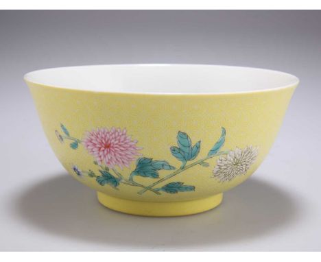 A CHINESE 'CARVED' YELLOW GROUND BOWL decorated with chrysanthemums in falangcai enamels, the interior decorated with five ir