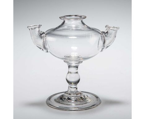 A DOUBLE-SPOUT GLASS OIL LAMP, CIRCA 1790 with knopped stem and folded foot. 13.5cm highChip to rim of one spout.