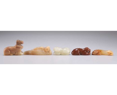 FIVE JADE CARVINGS comprising TWO RECUMBENT DOGS; A MYTHOLOGICAL CREATURE; A QILIN; and A RECLINING BUDDAH. (5) Reclining Bud
