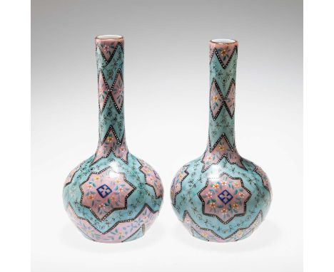 A PAIR OF 19TH CENTURY MOROCCAN WARE HARRACH GLASS BOTTLE VASES enamelled in blue and pink with floral decoration. (2) 24cm h