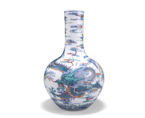 A CHINESE DOUCAI 'DRAGON' BOTTLE VASE the ovoid body rising from a recessed base to a tall cylindrical neck, decorated with b