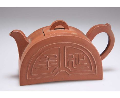 A CHINESE YIXING TEAPOT of half-round form, bears an impressed seal mark to the underside of the cover. 17.5cm longThere are 