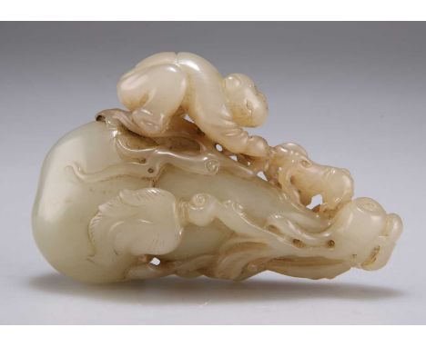 A CARVED JADE GROUP depicting a man climbing up a double gourd. 8cm by 5.5cmGood condition.