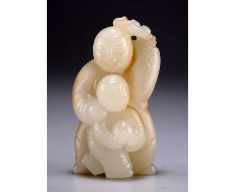 A CARVED JADE FIGURAL GROUP depicting a man holding a lingzhi fungus above his head with a child holding a ball. 8.5cm highGo