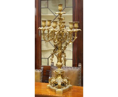A FRENCH ORMOLU SEVEN-LIGHT CANDELABRA, 19TH CENTURY with scrolling foliate scroll decoration and applied trailing floral dec