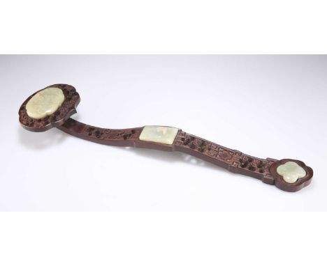 A CHINESE CARVED WOOD AND JADE INSET RUYI SCEPTRE  carved and pierced with cloud formations and inset with three jade plaques