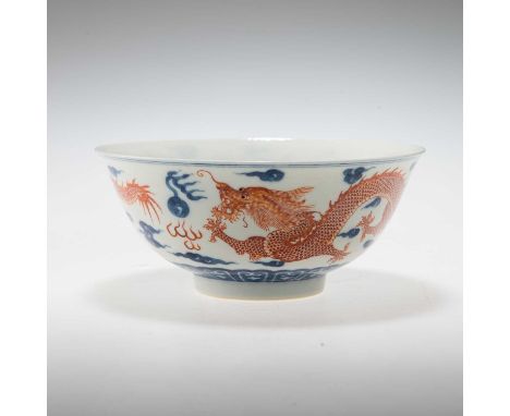 A CHINESE UNDERGLAZE BLUE AND IRON-RED DECORATED 'DRAGON' BOWL painted with a pair of iron-red dragons in pursuit of flaming 