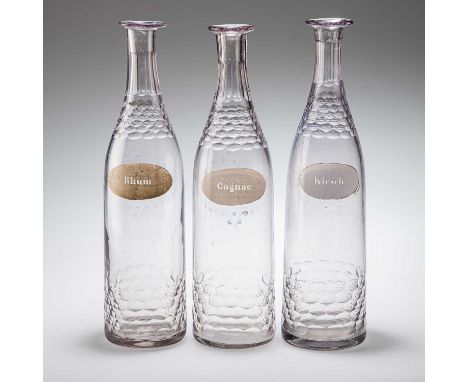 A SET OF THREE BACCARAT CUT-GLASS DECANTERS c.1890, labelled Rhum, Kirsch, Cognac, each with oval cutting, the cognac engrave