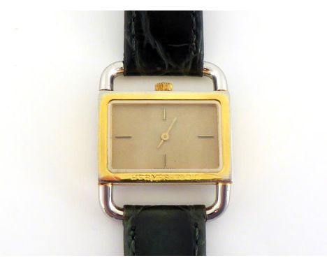 HERMES, a gilt metal quartz wrist watch, with 'driver's watch' style bezel and lugs, textured gilt dial, baton markers and ha