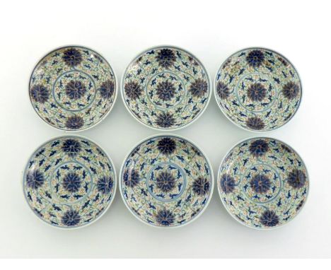 A set of six Chinese porcelain “Doucai”dishes, under glaze blue and white decorated scrolling lotus, and highlighted with gil