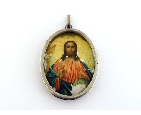 A Russian oval pendant icon, Christ Pantocrator, in unmarked silver-gilt frame with Cyrillic inscription dated "1887" to reve