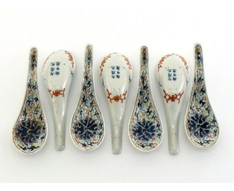 A set of seven Chinese porcelain “dou cai” spoons, under glazed blue and white decorated scrolling lotus, and highlighted wit