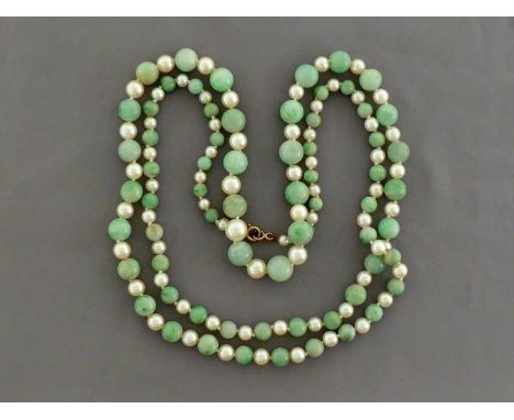 A jadeite and cultured pearl necklace, composed of graduated alternate jadeite beads and white body cultured pearls, to a gol