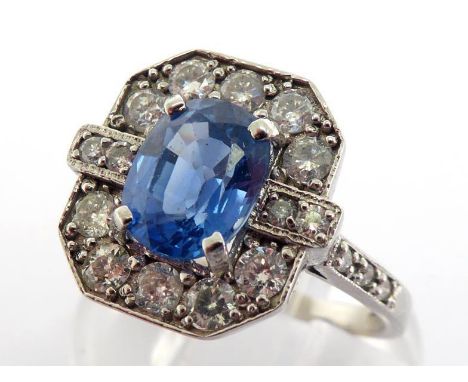 A sapphire and diamond plaque ring, the central oval cut sapphire totalling approx. 1.92 carats, in a surround of brilliant c