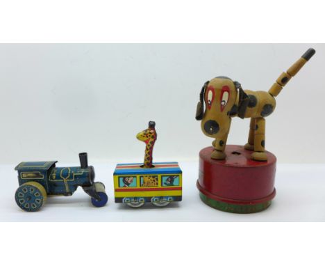 Three tin-plate toys; a German clockwork tractor, a Japanese train carriage with giraffe and a Tri-ang Wakouwa dog toy