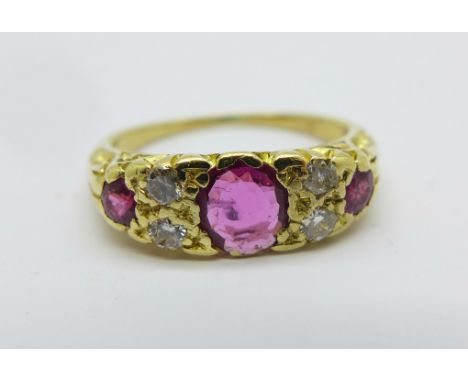 An 18ct gold, ruby and diamond seven stone ring, 4.6g, N