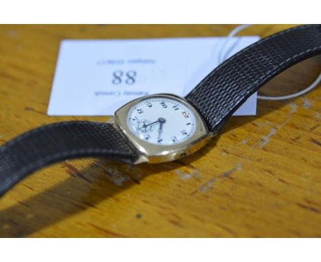 A 1930's 9ct gold cased wristwatch, the white enamel dial with Arabic numerals and subsidiary seconds dial, the case engraved