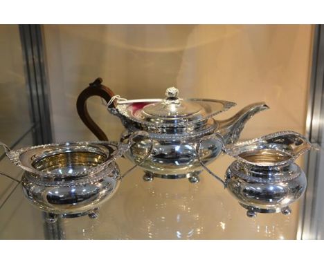 A George V silver three piece tea service, James Dixon & Sons, Sheffield 1917, each piece chased with gadrooned bands and rai