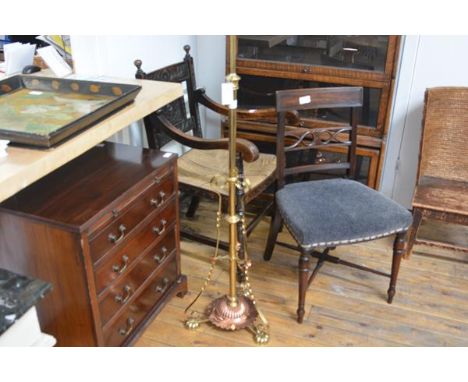 A copper and brass standing lamp in the Art Nouveau taste, the tripod base with cup feet beneath a columnar standard fitted w