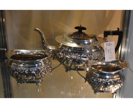 An Edwardian silver three piece tea service,  Joseph Gloster, Birmingham 1904, in the Rococo Revival taste, chased with c-scr