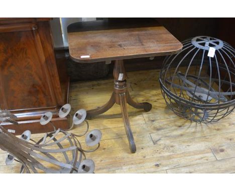 A George III mahogany tripod table, the square top with rounded corners, above a baluster standard over channelled legs termi