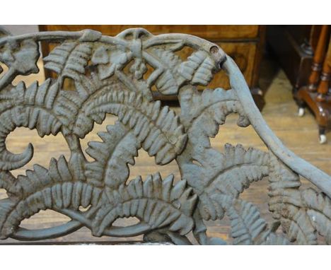 A cast iron garden bench in the Coalbrookdale style, weathered, the back and sides cast with ferns (lacking slatted wooden se