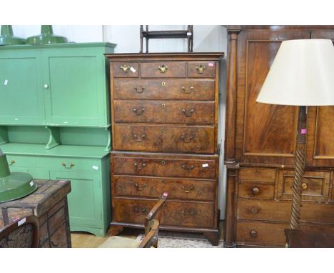 A George II walnut chest on chest, the moulded cornice above three short and three long graduated feather crossbanded drawers