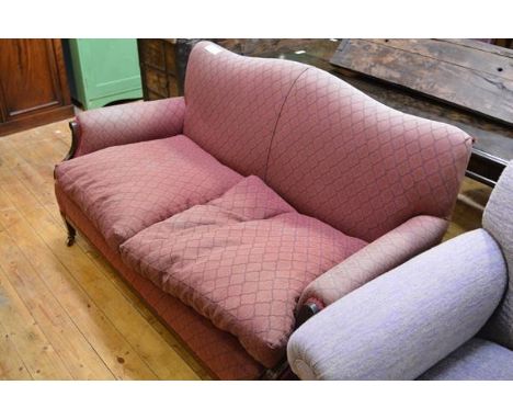 An early 20th century mahogany framed two seater sofa, with serpentine back, loose-cushioned seat and relief-carved frame. Le