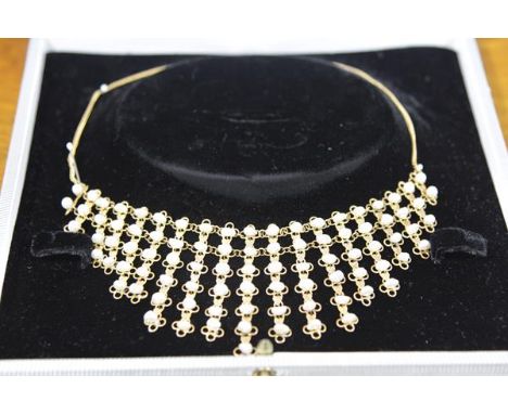 A cultured baroque pearl and yellow metal necklace, formed of graduated bands cast with hearts and loops and mounted with sma