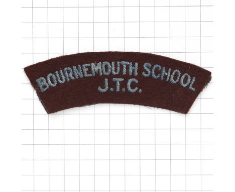 BOURNEMOUTH  SCHOOL / J.T.C. cloth shoulder title circa 1940-48. Light blue sans-serif letters embroidered on maroon felt   V