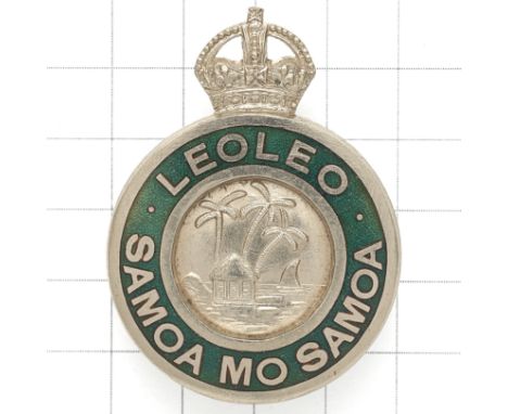 Samoa Police pre 1952 cap badge. Die-cast British made crowned green enamel ‘LEOLEO SAMOA MO SAMOA’ circlet with Palm Trees, 