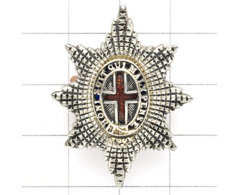 Coldstream Guards Officer’s Service Dress cap badge. Unmarked die-cast facetted Garter Star mounted with gilt pierced Garter 
