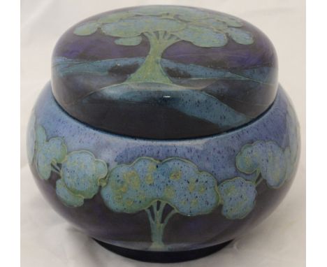 A circa 1930 William Moorcroft "Moonlit Blue" pattern jar with screw cover, tube lined with stylised trees in a landscape pic