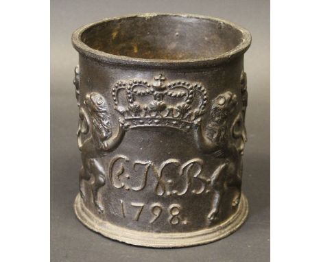 An 18th Century patinated cast iron tobacco jar, decorated to one side with Coat of Arms as a crown held aloft by two outward