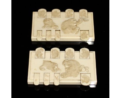 A pair of Japanese Meiji period carved ivory bezique markers, decorated with monkeys and insects, 9.5 cm x 6 cm CONDITION REP