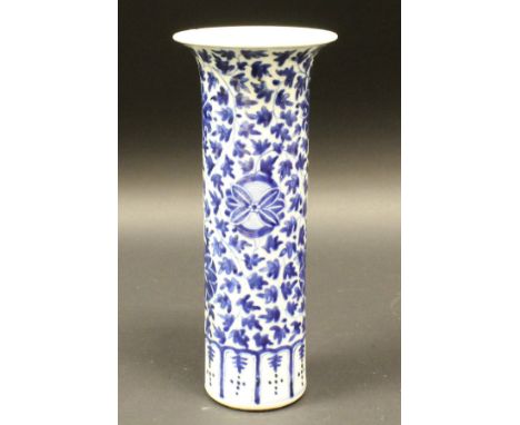 A 19th Century blue and white Chinese cylindrical vase with flared rim, the main body decorated with scrolling foliage and fl