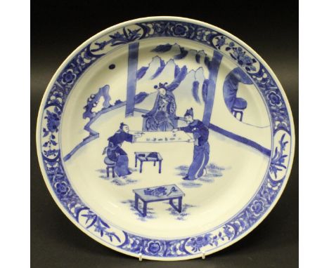 A Chinese blue and white porcelain plate, the centre field decorated with scholars writing upon a scroll within a floral deco