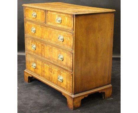 An oyster walnut and mahogany banded square chest of two short over three long graduated drawers in the 18th Century manner, 