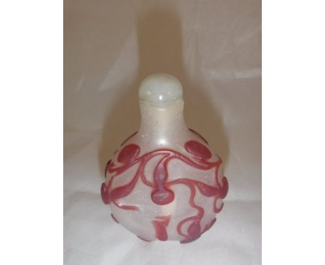 A 19th Century Chinese ruby glass overlaid scent bottle with scrolling foliate decoration, 7 cm high CONDITION REPORTS Lid is