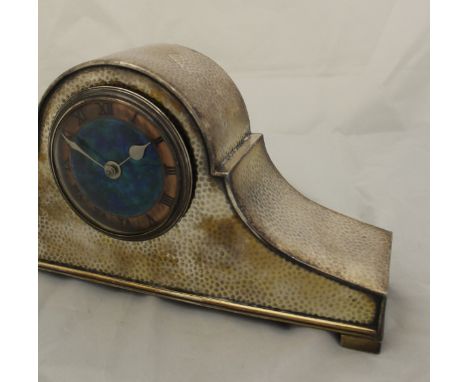 A Liberty & Co Tudric Pewter mantle clock with copper and blue enamelled dial and Roman numerals, the base stamped "Made in E