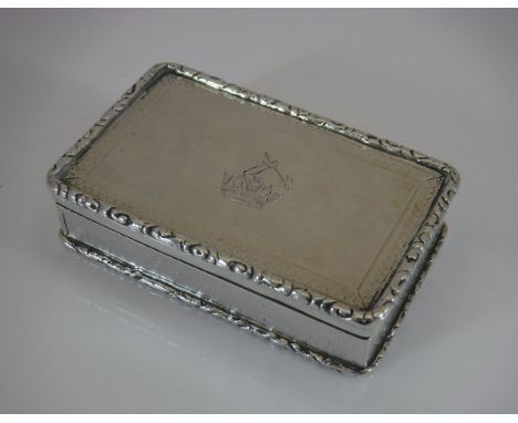 A William IV silver snuff box of rectangular form with raised edging and engine turned decoration, the lid bearing armorial o