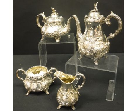 A Victorian silver and embossed four piece tea set comprising teapot, hot water jug, twin-handled sugar basin and cream jug (