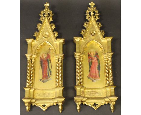A pair of 19TH CENTURY ITALIAN SCHOOL religious icons of angels playing musical instruments in a Gothic style giltwood archit