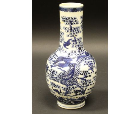 A Chinese blue and white gourd shaped vase decorated with five toed dragon amongst clouds and bats bearing Qianlong serial sc