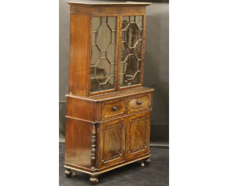 A late Regency mahogany secretaire bookcase cabinet in the Gillows manner, the upper section with bobbin decorated cornice, a