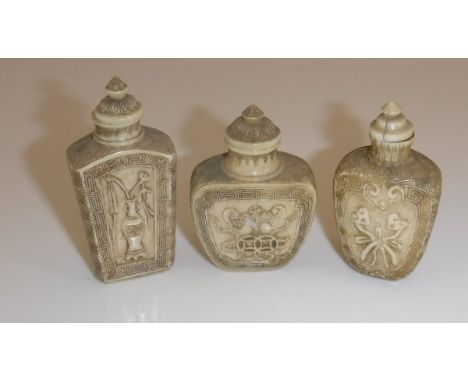 A collection of three 19th Century Chinese ivory snuff bottles with relief work decoration within Greek key borders, 6.5 cm h