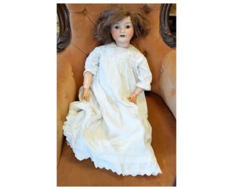 Vintage 20th Century bisque headed children's doll wearing a white dress, no makers mark present, measures approximately 60cm